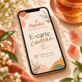 E-carte cadeau Papothé affichée sur un smartphone, dans un univers doux et floral avec une tasse de thé et des bonbons à infuser.