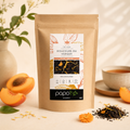 Thé Noir Pêche Abricot Douceurs du Verger Papothé en sachet kraft, présenté avec pêche, abricot, thé noir et tasse chaude.